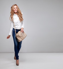 Beautiful happy woman holding a bag 