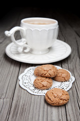 Cup of tea and cookies on wooden background