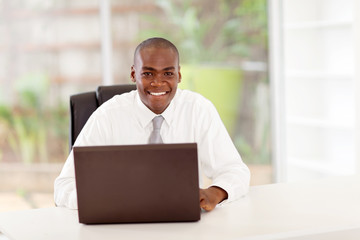 happy young african american businessman in office