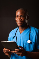 african american medical doctor with tablet computer over black