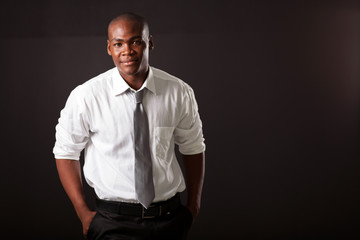 handsome young african american man on black background