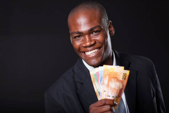 happy african businessman with south african cash notes