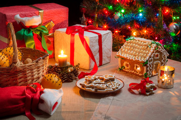 Presents and gingerbread cookies on the table on Christmas Eve