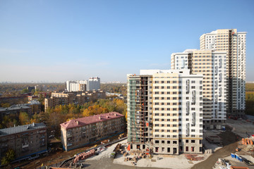 Naklejka premium Three buildings under construction