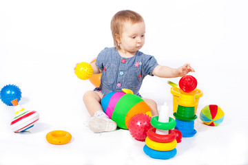 Small child plays with toys. Studio shoot. Isolated