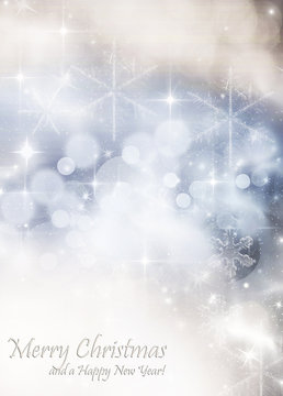 Light bokeh abstract Christmas background with white snowflakes