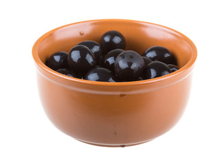 Olives black watered with olive oil in a bowl isolated on a whit