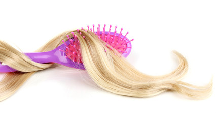 Blond curls brushing comb isolated on white