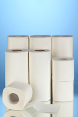 Rolls of toilet paper on blue background