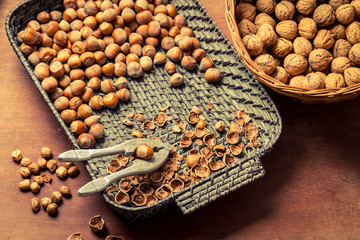 Hazelnuts with nutcracker and nutshel in old basket