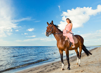 girl with horse on seacoast
