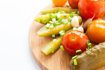 Pickled vegetables - assorted on a wooden surface