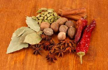Nutmeg and other spices on wooden background