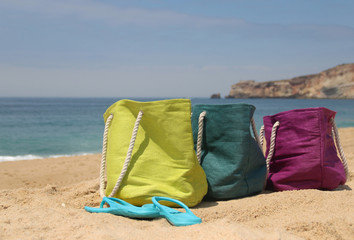 Summer holiday – three vivid bags on the seacoast