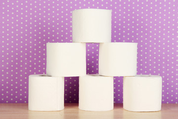 Rolls of toilet paper on purple with dots background