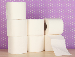 Rolls of toilet paper on purple with dots background