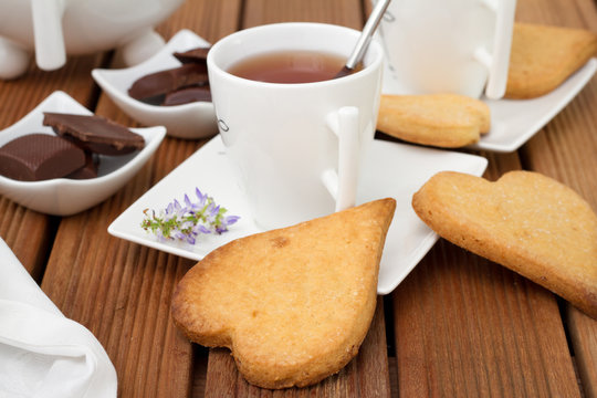 cup of tea with cookies and chocolate