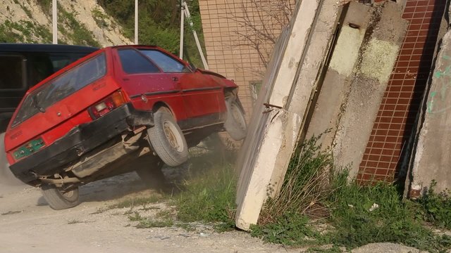 red car crashed into a concrete wall