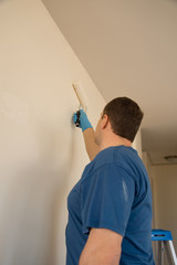 Painter painting wall © Globalphotogroup