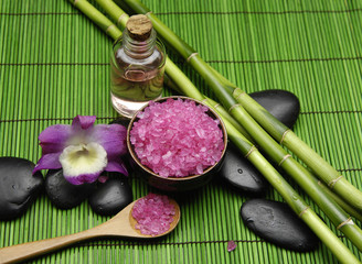 Pink orchid with salt in bowl and massage oil ,grove