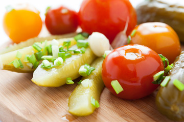 Pickled vegetables - cucumbers, tomatoes close-up on the kitchen
