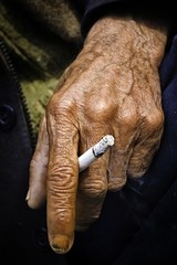 an old smoker is smoking cigarette