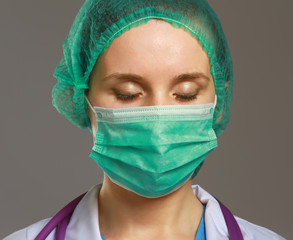 Closeup portrait of a young doctor wearing a mask