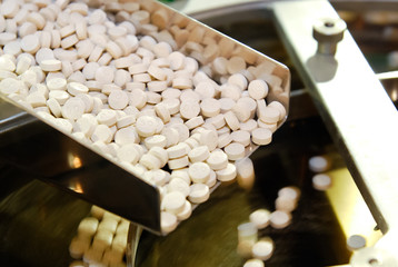 Closeup of pharmaceutical medicine tablet pill production in the