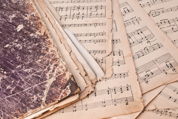 Fragment shabby book lay on the sheets with notes