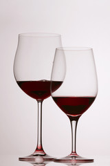 Two glasses of red wine on white background