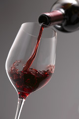 Pouring red wine into the wine glass