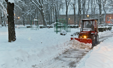 snowplow Tractor cleaning snow in the park