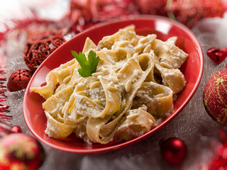 pasta with ricotta and pine nuts on christmas table, selective f
