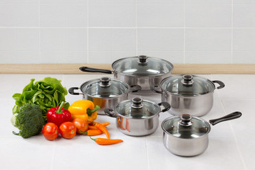 Set of stainless pots and pan with glass lids © venusangel
