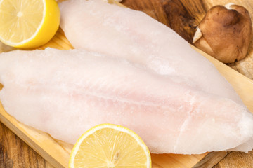 Delicious raw fish fillet with lemon. Culinary seafood eating