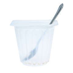 Empty cup of yogurt with a spoon. On a white background.