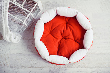 Red pet mattress in the room with cage