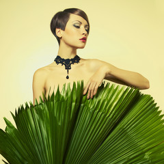 Fototapeta premium Beautiful lady with palm leaves
