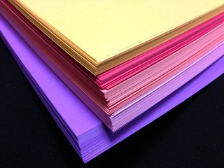 Assorted Colored Pile of Papers on Black Background