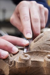 craftsman carving with a gouge