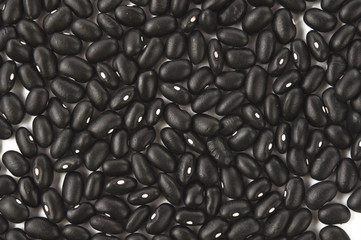Texture of small black beans. © ksena32