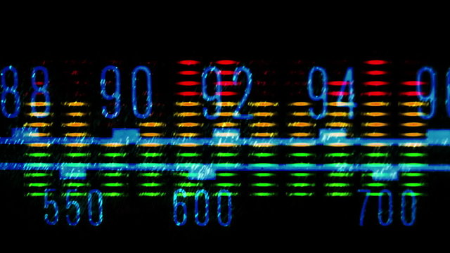 a glowing radio with the marker running through stations