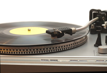 Turntable with vinyl record with yellow label isolated closeup