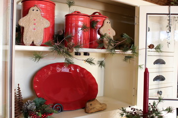 Colorful red jars in white cupboard