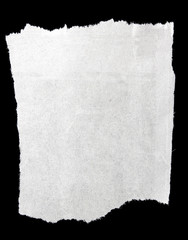 Piece of ripped white paper on black