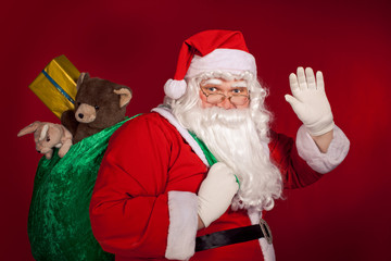 Santa Claus greeting and holding his bag