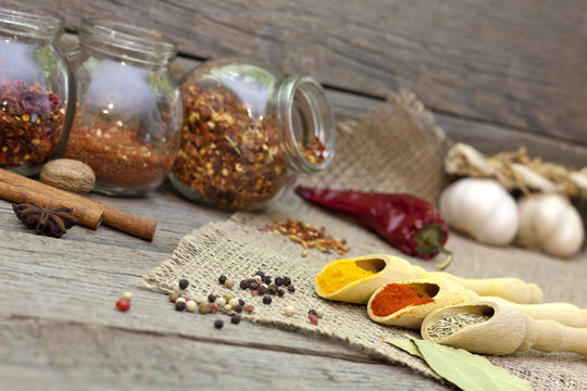 Spices and herbs on old vintage wooden boards in the kitchen