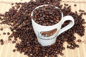 Close up coffee bean in a white cup