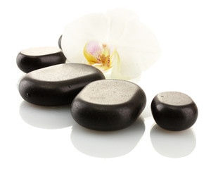 Spa stones and orchid flower, isolated on white.