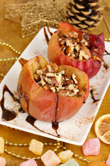 Baked apples on plate on wooden table
